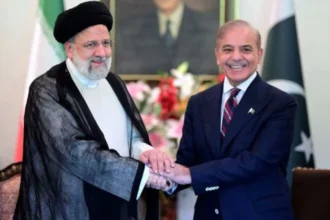 Iranian President Ebrahim Raisi, left, shakes hand with Pakistan's Prime Minister Shehbaz Sharif (Iran and Pakistan)